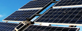 Close up view of rack mounted solar panels against a blue sky