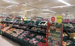 Interior view of the produce aisle at a Tesco supermarket