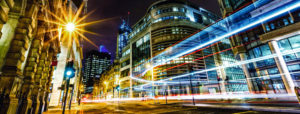Concept image shows streaks of light moving through a business district in downtown London at night