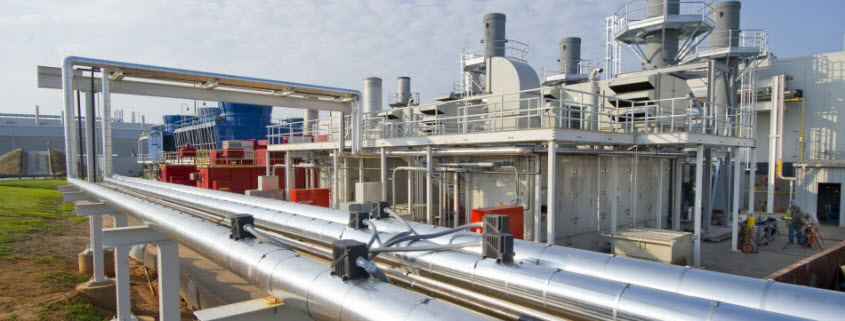 Daytime view of a cogeneration plant with piping in the foreground