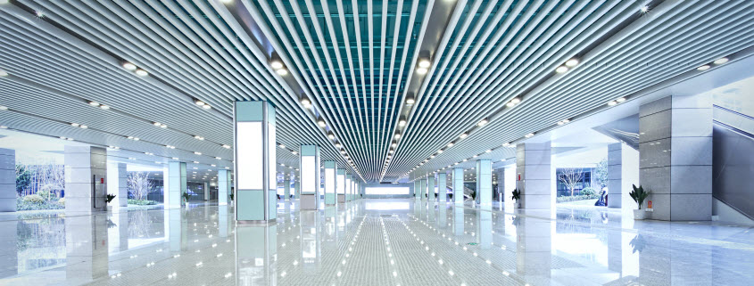 Interior view of a modern office building lobby lit with LED lighting