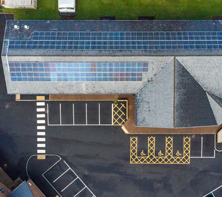 Daytime overhead view of solar panels on a building in Carmathanshire Wales